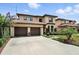 Spacious two-story home featuring a three-car garage and lush, green landscaping at 1769 Turnberry Ter, Orlando, FL 32804