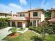 Stately two-story home with a red tile roof, three-car garage, and mature landscaping at 1769 Turnberry Ter, Orlando, FL 32804