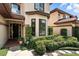 Front view of a well-maintained home with brick accents, manicured landscaping, and an ADT security sign at 1769 Turnberry Ter, Orlando, FL 32804