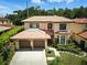 Beautiful two-story home with a well-manicured lawn and a three-car garage at 1769 Turnberry Ter, Orlando, FL 32804