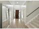 Inviting entryway with hardwood floors, high ceilings, a dark wood front door, and staircase at 1769 Turnberry Ter, Orlando, FL 32804