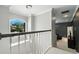 Hallway with high ceilings featuring hanging chandelier and views of the neighborhood at 1769 Turnberry Ter, Orlando, FL 32804