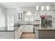 Contemporary kitchen featuring white cabinets, stainless steel appliances, and a center island at 1769 Turnberry Ter, Orlando, FL 32804