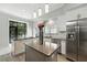 Bright kitchen with a center island, white cabinetry, and stainless steel refrigerator at 1769 Turnberry Ter, Orlando, FL 32804