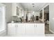Open-concept kitchen with white cabinetry, a center island, and stainless steel appliances at 1769 Turnberry Ter, Orlando, FL 32804