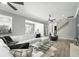 Bright living room with hardwood floors, neutral walls, featuring a fireplace and views of the dining room at 1769 Turnberry Ter, Orlando, FL 32804