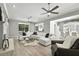 Airy living room with a fireplace, sectional sofa, and seamless flow to dining area at 1769 Turnberry Ter, Orlando, FL 32804