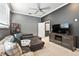 Cozy living room with carpet floors, a TV and comfortable seating arrangements at 1769 Turnberry Ter, Orlando, FL 32804
