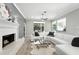 Inviting living room features a fireplace, large window, and white sectional sofa at 1769 Turnberry Ter, Orlando, FL 32804