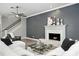 Comfortable living room featuring a fireplace, white crown molding, neutral walls, and stylish decor at 1769 Turnberry Ter, Orlando, FL 32804