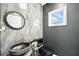 Stylish powder room with modern fixtures and gray marble wall at 1769 Turnberry Ter, Orlando, FL 32804