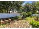 Fenced backyard with a gazebo, landscaped area, and a retaining wall at 204 Grovepark Dr, Davenport, FL 33837