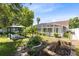 The backyard is fenced, landscaped, and features a screened-in pool and gazebo at 204 Grovepark Dr, Davenport, FL 33837