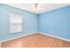 Clean bedroom with hardwood floors, a ceiling fan, and a window at 204 Grovepark Dr, Davenport, FL 33837
