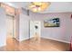 Spacious bedroom with hardwood floors, a ceiling fan, and an ensuite bathroom at 204 Grovepark Dr, Davenport, FL 33837