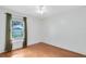 Clean bedroom with hardwood floors, a ceiling fan, and a window at 204 Grovepark Dr, Davenport, FL 33837