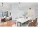 Open-concept dining room with a marble table and seating for six, next to a living area at 204 Grovepark Dr, Davenport, FL 33837