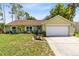 Charming single-story home with well-manicured lawn, a front yard, and a two car garage at 204 Grovepark Dr, Davenport, FL 33837