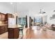 Open kitchen with granite counters, wooden cabinets, a breakfast bar, and views of the living area at 204 Grovepark Dr, Davenport, FL 33837