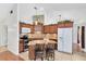 Well-equipped kitchen with granite countertops, wood cabinets, and modern stainless steel appliances at 204 Grovepark Dr, Davenport, FL 33837