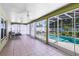 Enclosed lanai featuring screened windows and views of the pool at 204 Grovepark Dr, Davenport, FL 33837
