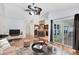 Open concept living room and kitchen with hardwood floors and sliding glass doors to the lanai at 204 Grovepark Dr, Davenport, FL 33837