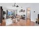 Bright living room featuring hardwood floors, a ceiling fan, and a large window for natural light at 204 Grovepark Dr, Davenport, FL 33837