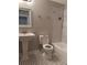 Charming bathroom featuring a pedestal sink, tile floors, and shower with marble tile surround at 2065 Dixie Belle Dr # O, Orlando, FL 32812