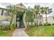Inviting two-story building with stairs, beautiful trees and lush landscaping adds to the welcoming curb appeal at 2065 Dixie Belle Dr # O, Orlando, FL 32812