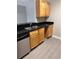 Kitchen featuring stainless steel appliances, light wood cabinets and black countertops at 2065 Dixie Belle Dr # O, Orlando, FL 32812
