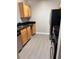 Bright kitchen featuring stainless steel appliances and wood cabinets with black countertops at 2065 Dixie Belle Dr # O, Orlando, FL 32812