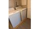 Laundry room featuring a white washer and dryer and a wood-look floor at 2065 Dixie Belle Dr # O, Orlando, FL 32812