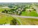 Beautiful aerial view of a neighborhood with homes, green spaces, and access to a nearby golf course at 2173 Caledonian St, Clermont, FL 34711