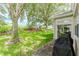 Beautiful backyard with lush green grass, mature trees and outdoor grill at 2173 Caledonian St, Clermont, FL 34711