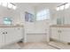 Bathroom features a soaking tub nestled between dual vanities with stone counters at 2173 Caledonian St, Clermont, FL 34711