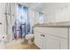 Bright bathroom featuring a shower with a vibrant floral curtain and a white vanity at 2173 Caledonian St, Clermont, FL 34711