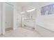 Bright bathroom featuring a glass shower, soaking tub, neutral tile floors, and white cabinets at 2173 Caledonian St, Clermont, FL 34711