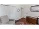 Bedroom with hardwood floors, neutral paint, and comfortable lounge chair at 2173 Caledonian St, Clermont, FL 34711