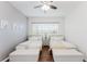 Cozy bedroom featuring two twin beds with padded benches at the end at 2173 Caledonian St, Clermont, FL 34711