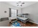 Bedroom with bunk beds, storage cabinet, and playful space-themed rug at 2173 Caledonian St, Clermont, FL 34711