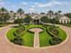 Beautiful clubhouse featuring meticulously manicured landscaping, brick walkways, and majestic palm trees at 2173 Caledonian St, Clermont, FL 34711