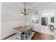 Dining room area with modern lighting, neutral paint and view into living area at 2173 Caledonian St, Clermont, FL 34711