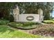 Elegant Summit Greens community entrance sign surrounded by manicured landscaping and mature trees at 2173 Caledonian St, Clermont, FL 34711