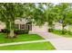 Charming home featuring a well-manicured lawn, mature trees, and a two-car garage at 2173 Caledonian St, Clermont, FL 34711