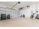Spacious three car garage with a smooth concrete floor and overhead storage at 2173 Caledonian St, Clermont, FL 34711