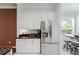 Kitchen features granite countertops, stainless refrigerator and view to breakfast nook and backyard at 2173 Caledonian St, Clermont, FL 34711