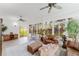 Inviting sunroom featuring tile flooring, a ceiling fan, and comfortable seating at 2173 Caledonian St, Clermont, FL 34711
