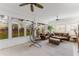Bright sunroom featuring tile flooring, a ceiling fan, and comfortable seating at 2173 Caledonian St, Clermont, FL 34711