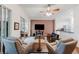 Comfortable living room featuring hardwood floors, ceiling fan, cozy seating and open access to the kitchen at 2173 Caledonian St, Clermont, FL 34711