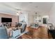 Spacious living room featuring hardwood floors, ceiling fan, comfortable seating and view of the dining area at 2173 Caledonian St, Clermont, FL 34711